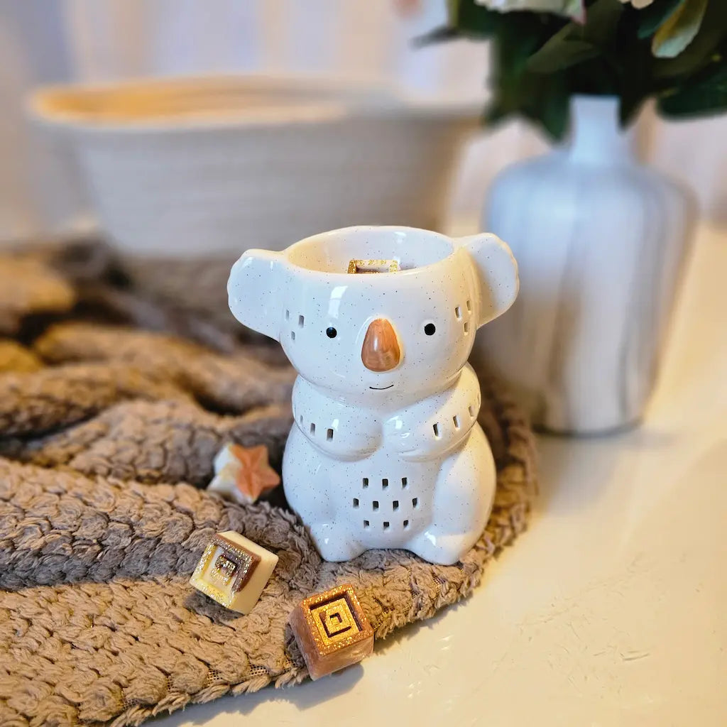 Brûle-parfums en forme de koala sur plaid cocooning